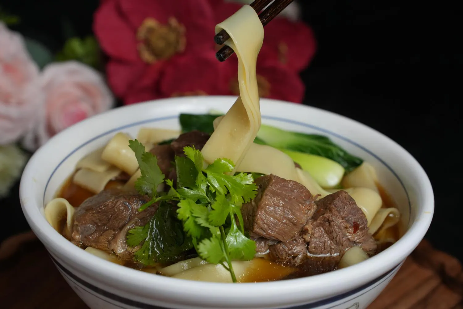Braised beef wide noodles with cilantro and greens
