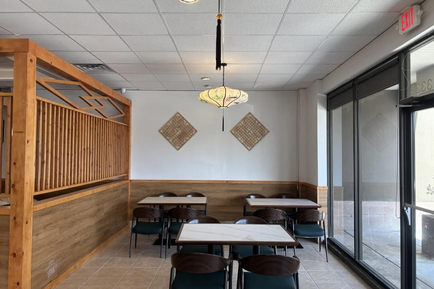 Bright dining area with wooden partitions and Chinese lantern light